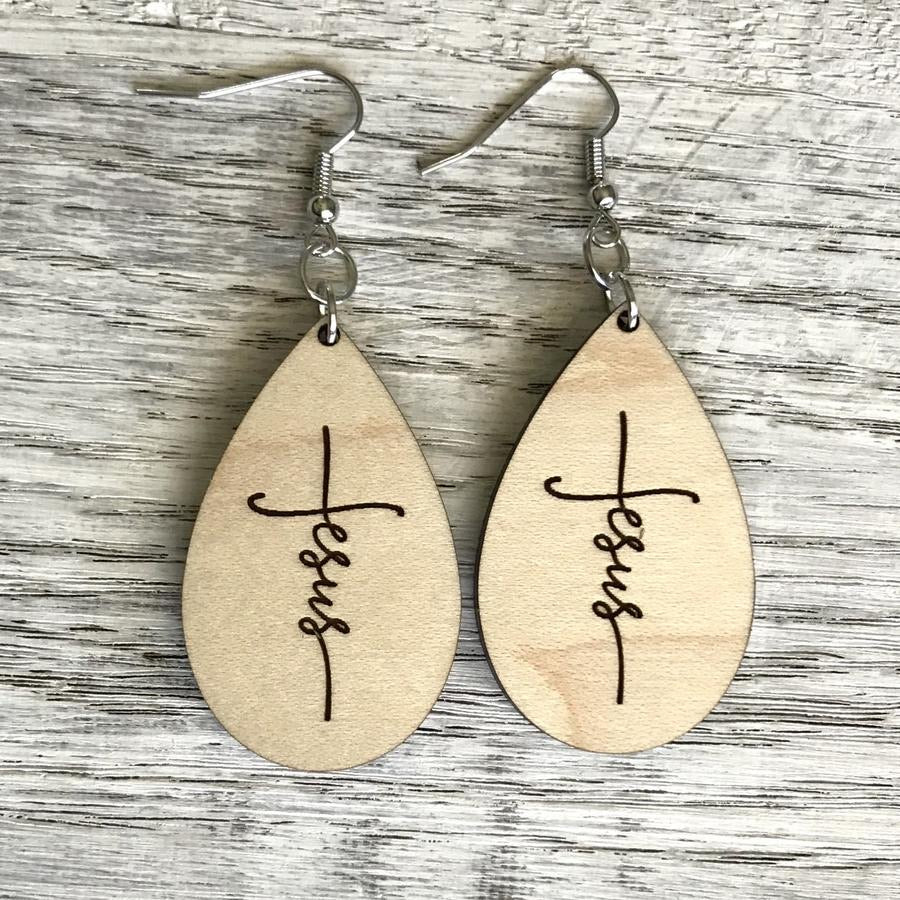 wooden drop earrings with the name of jesus laser engraved in the shape of a cross